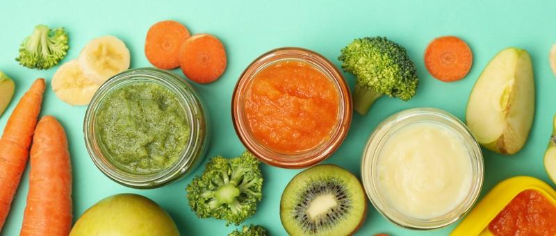 Top view of various vegetables and fruits against blue background